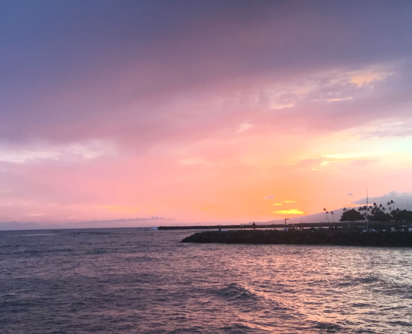 view of the pier from the ocean at sunset.